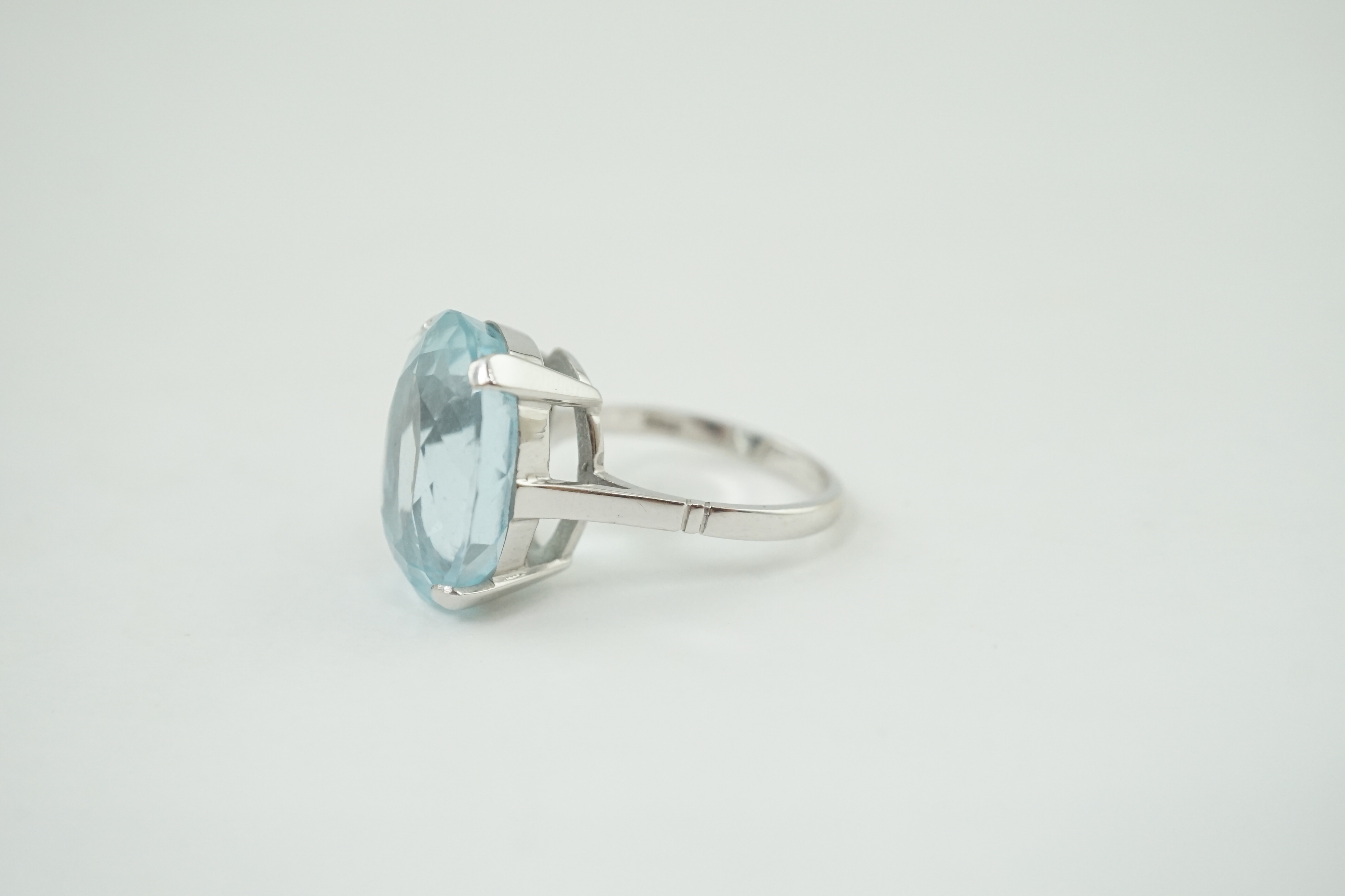 A mid 20th century 18ct white gold and single stone oval cut aquamarine set dress ring